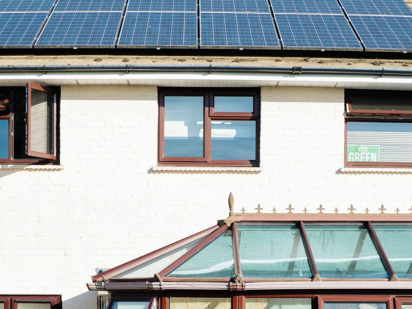 Solar panels on the roof of a white-painted house